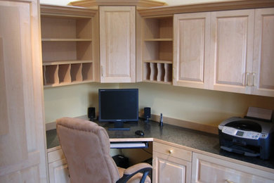 Mid-sized elegant built-in desk study room photo in Seattle with white walls