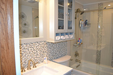 Small transitional multicolored tile and mosaic tile porcelain tile bathroom photo in Columbus with an undermount sink, shaker cabinets, blue cabinets, quartz countertops, a one-piece toilet and blue walls