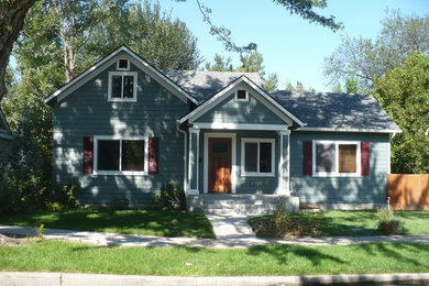 Mid-sized elegant blue two-story wood exterior home photo in Boise with a shingle roof