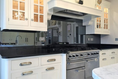 Design ideas for a contemporary single-wall kitchen in London with grey splashback and glass sheet splashback.