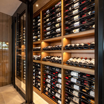 Modern Bronze Steel Wine Wall and Liquor Display in Luxury Custom Home Basement