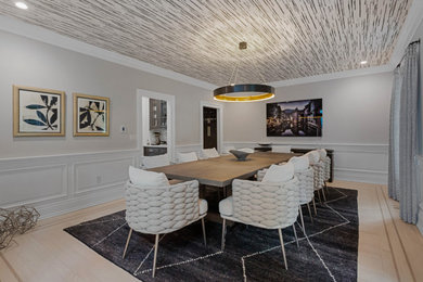 Large transitional light wood floor, wallpaper ceiling, beige floor and wainscoting kitchen/dining room combo photo in New York with beige walls and no fireplace