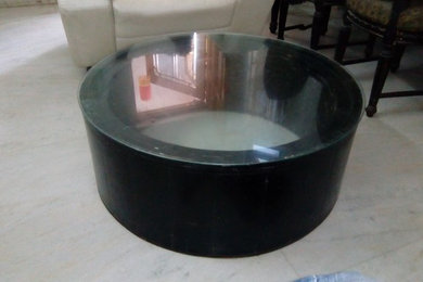 Round coffee table inside carved top glass