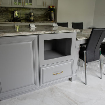 Transitional Kitchen Done in a 2 Tone Color With Integrated Dining Table