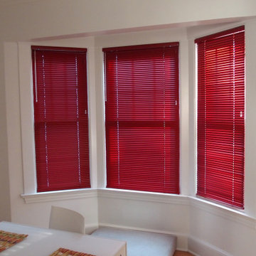 Window treatments in a white living room and kitchen