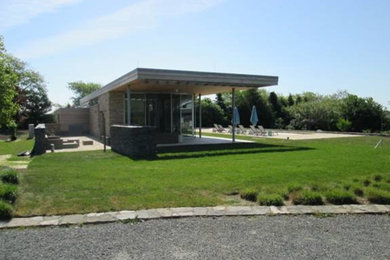 Inspiration for a large contemporary one-story stone exterior home remodel in Providence