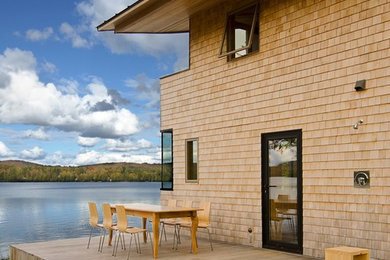Example of a mountain style side yard deck design in Other with no cover
