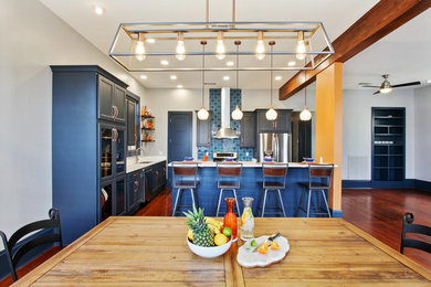 Large eclectic l-shaped medium tone wood floor and brown floor eat-in kitchen photo in New Orleans with an undermount sink, flat-panel cabinets, blue cabinets, quartz countertops, blue backsplash, ceramic backsplash, stainless steel appliances, an island and white countertops