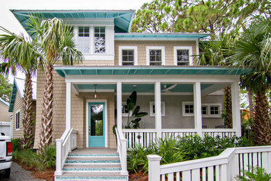 Large coastal beige two-story vinyl house exterior idea in Jacksonville with a hip roof