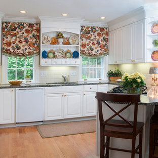 Traditional kitchen pantry ideas - Kitchen pantry - traditional medium tone wood floor kitchen pantry idea in Bridgeport with white cabinets, white backsplash and black appliances