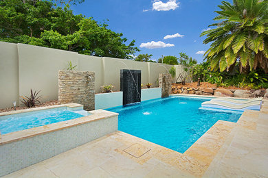 Design ideas for a mid-sized modern front yard custom-shaped pool in Sunshine Coast with a water feature and tile.