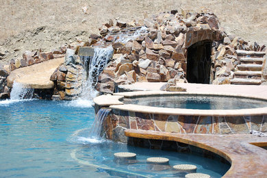 This is an example of a transitional backyard pool in Sacramento with a water slide.