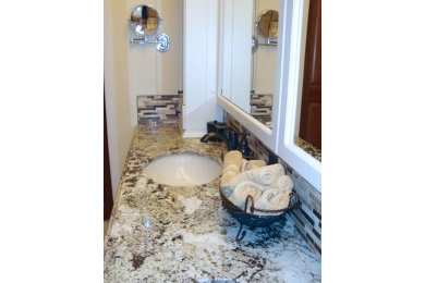 Minimalist multicolored tile bathroom photo in Other with granite countertops