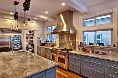 Inspiration for a large arts and crafts u-shaped open plan kitchen in Minneapolis with an undermount sink, shaker cabinets, blue cabinets, copper benchtops, metallic splashback, metal splashback, stainless steel appliances, medium hardwood floors, with island and brown floor.