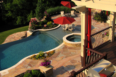Example of a huge classic backyard stone and custom-shaped lap hot tub design in New York