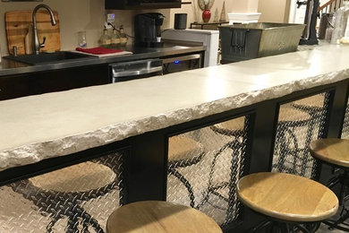 Mid-sized trendy galley concrete floor seated home bar photo in Philadelphia with flat-panel cabinets, dark wood cabinets, wood countertops, beige backsplash and a drop-in sink