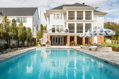 Trendy backyard concrete paver and rectangular pool photo in DC Metro