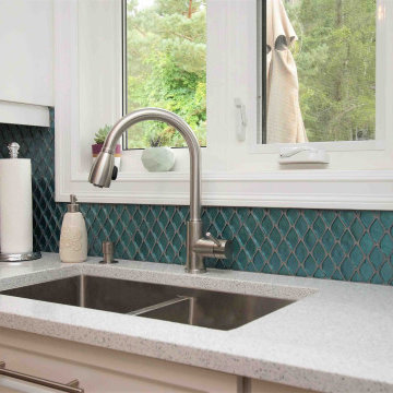 L-Shape white kitchen with Quartz top with blue accents