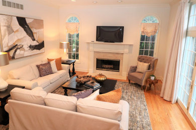 Inspiration for a huge open concept medium tone wood floor family room remodel in Philadelphia with beige walls and a tv stand