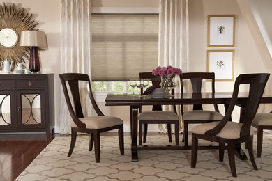 Mid-sized elegant medium tone wood floor enclosed dining room photo in Charleston with beige walls