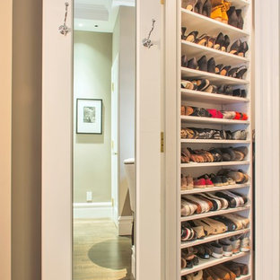 Example of a small classic gender-neutral medium tone wood floor walk-in closet design in Orange County with open cabinets and white cabinets