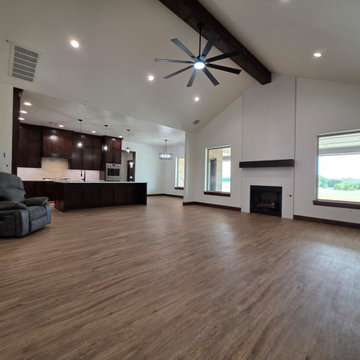 The large windows on each side of the fireplace offer stunning views of the coun