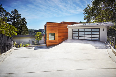 Large modern three-storey grey house exterior in San Francisco with mixed siding, a shed roof and a metal roof.