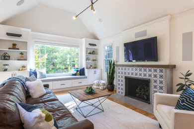 Transitional medium tone wood floor and brown floor living room photo in San Francisco with beige walls, a standard fireplace, a tile fireplace and a wall-mounted tv