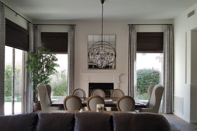 Example of a large transitional medium tone wood floor and brown floor great room design in Phoenix with white walls, a standard fireplace and a wood fireplace surround