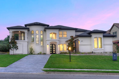 Inspiration for a large modern white two-story stucco exterior home remodel in Austin