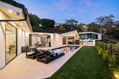 Example of a minimalist backyard concrete and rectangular pool design in Los Angeles with a bbq area