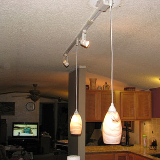 Large modern kitchen pantry designs - Kitchen pantry - large modern l-shaped dark wood floor kitchen pantry idea in Wichita with an undermount sink, flat-panel cabinets, light wood cabinets, quartz countertops, beige backsplash, ceramic backsplash, stainless steel appliances and an island