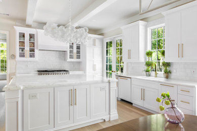 Example of a large transitional u-shaped eat-in kitchen design in Dallas with shaker cabinets, white cabinets, paneled appliances and an island