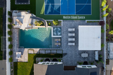 Example of a large transitional backyard concrete paver and rectangular pool house design in Salt Lake City