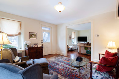 Mid-sized transitional medium tone wood floor and brown floor entryway photo in Philadelphia with white walls and a white front door