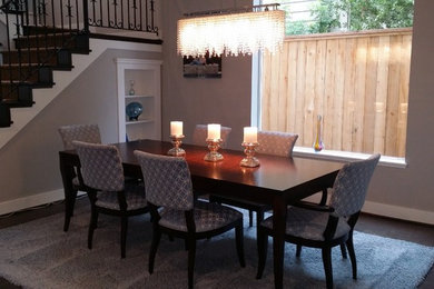 Inspiration for a mid-sized transitional dark wood floor and brown floor great room remodel in Houston with gray walls and no fireplace