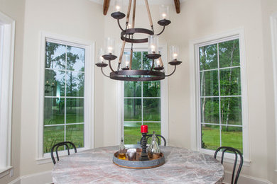Example of a farmhouse medium tone wood floor enclosed dining room design in New Orleans with white walls