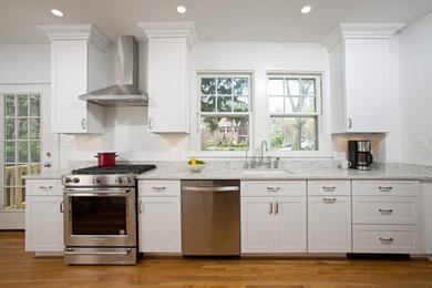 Inspiration for a large modern galley medium tone wood floor eat-in kitchen remodel in DC Metro with marble countertops and no island