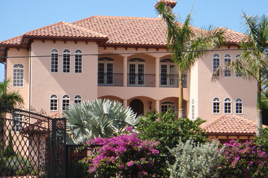 Example of a large island style two-story exterior home design in Tampa