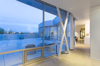 Example of a small trendy open concept concrete floor family room design in Chicago with white walls