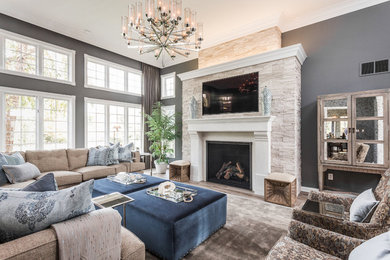 Large transitional formal and enclosed light wood floor living room photo in New York with gray walls, a standard fireplace, a plaster fireplace and a wall-mounted tv