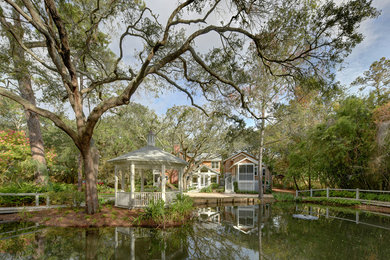 Design ideas for a large transitional front yard pond in Jacksonville.