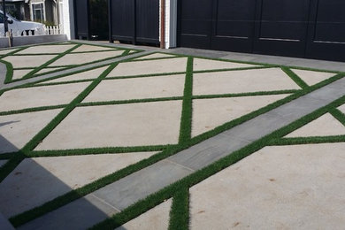 Photo of a large modern full sun side yard concrete paver driveway in Los Angeles.
