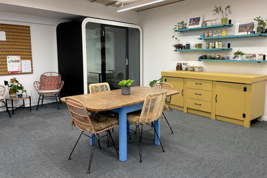 This is an example of a large eclectic study in London with white walls, carpet, a freestanding desk, blue floors, a timber clad ceiling and feature lighting.