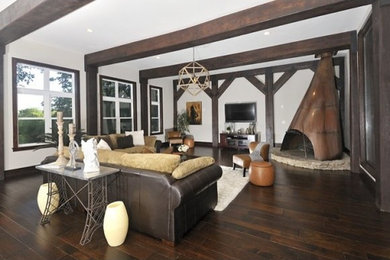 Inspiration for a large transitional open concept dark wood floor and brown floor living room remodel in Other with white walls, no fireplace and a wall-mounted tv
