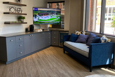 Example of a large trendy freestanding desk laminate floor, gray floor and wallpaper home office design in Denver with beige walls
