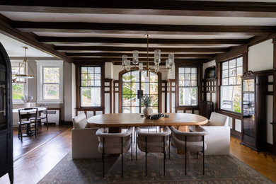 Example of a large classic medium tone wood floor, brown floor, coffered ceiling and wainscoting kitchen/dining room combo design in New York