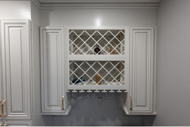 Example of a large transitional galley open concept kitchen design in Montreal with raised-panel cabinets, beige cabinets, quartz countertops, an island and multicolored countertops