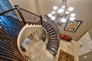 Mid-sized traditional wood curved staircase in Other with painted wood risers and wood railing.