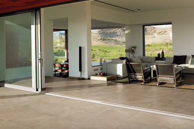 Inspiration for a large contemporary open concept porcelain tile living room remodel in Orange County with white walls, no fireplace and no tv